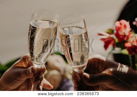 Marriage And Wedding Concept. Romantic Couple In Love Celebrate Their Wedding Day, Clink Glasses Of 