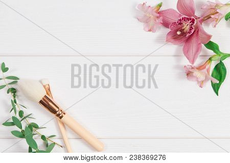 Decorative Flat Lay Composition With Makeup Products And Flowers. Flat Lay, Top View On White Backgr