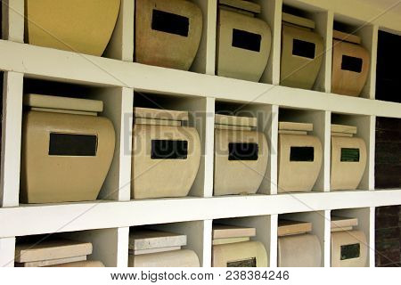 Urns With Ashes In A Columbarium Wall