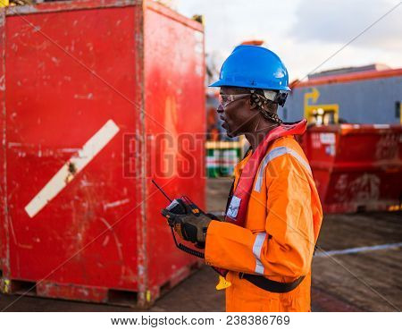 Seaman Ab Or Bosun On Deck Of Offshore Vessel Or Ship Standing Near Cargo Container. Marine Cargo Op