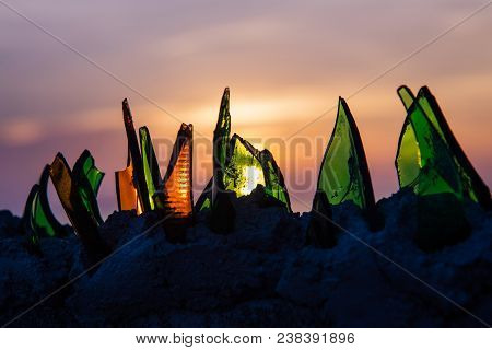 Broken Colorful Bottle Glass At Sunset On Background