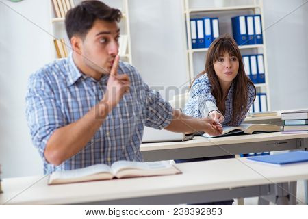 Students sitting and studying in classroom college