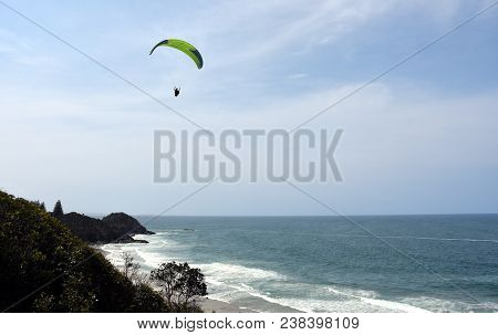 Paraglider Flying Over The Sea With Blue Water And Mountains In Bright Sunny Day. Aerial View Of Par