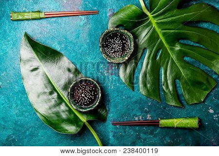 Asian Food Concept. Chopstick And Soysauce Soy Sauce With White Sesame On Turquoise Background With 