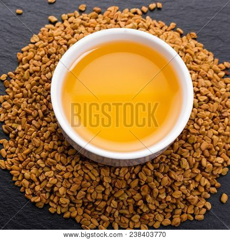 Fragrant Grains Of Fenugreek On A Rustic Background.
