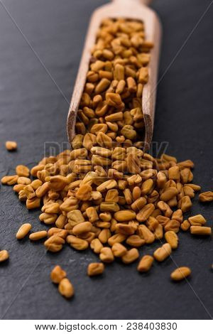 Fragrant Grains Of Fenugreek On A Rustic Background.