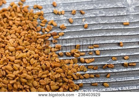 Fragrant Grains Of Fenugreek On A Rustic Background.