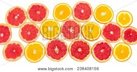 Round Slices Of The Ripe Red Grapefruits And Oranges With Peel On A White Background