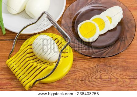 Egg Slicer With Egg In It Closeup, Boiled Whole Peeled And Partly Sliced Eggs In Different Sausers O