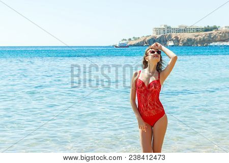 Beautiful Happy Woman On Tropical Beach In Swimsuit And Sunglassses.