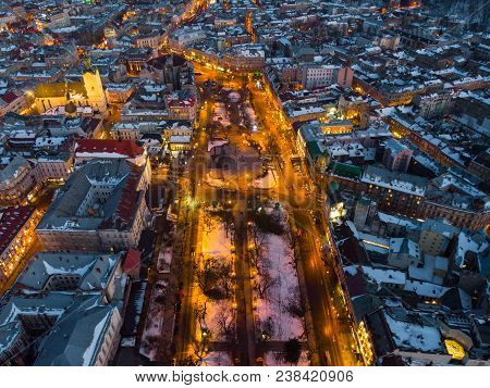 Aerial View Of City In Night Time. Streets In Car Lights.