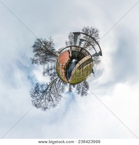 Green Little Tiny Planet With Trees Near Gateway Lock Sluice Construction On River, White Clouds And