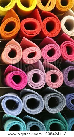 Many Colored Big Rolls Of Fabric In The Shelf Of The Tailoring
