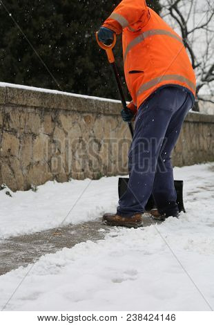 Snow Spreader With High Visibility Jacket Shovels The Sidewalks After The Snowfall