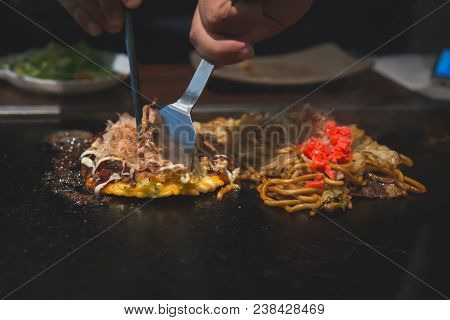 Chef Cooking Okonomiyaki; Japanese-style Pancake Or Pizza