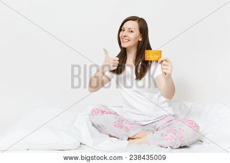 Young Fun Happy Woman Sitting In Bed With White Sheet, Pillow, Wrapping In Blanket On White Backgrou