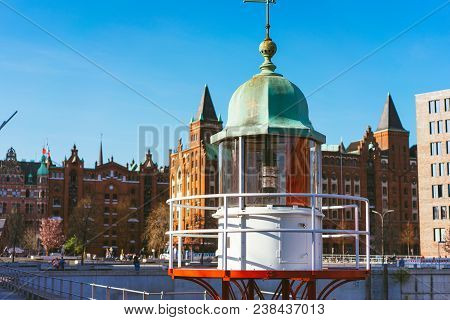 Close Up Of Old Beacon Lighthouse And Red Brick Building In Background, Hafencity - Speicherstadt In