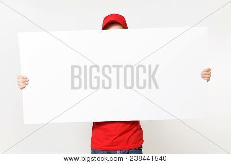 Delivery Young Man In Red Uniform Isolated On White Background. Male Courier In Cap T-shirt Holding