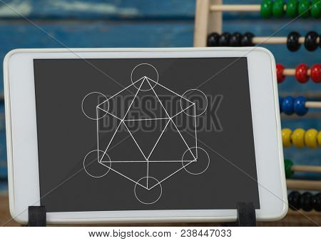 Tablet on a school table with school icons on screen