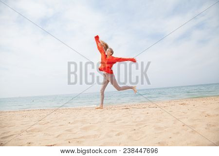 Blonde Girl Jumping On A Sandy Beach Sea Shore 1