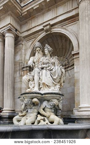 Vienna, Austria - 15 April 2018: People Sit On The Steps Near The Fountain Monument