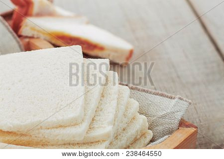 Sliced Of Bread On A Wooden Floor.