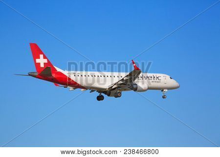ZURICH - JULY 18: Helvetic A-320 landing in Zurich airport on July 18, 2015 in Zurich, Switzerland. Zurich airport is home port for Swiss Air and several budget airlines.