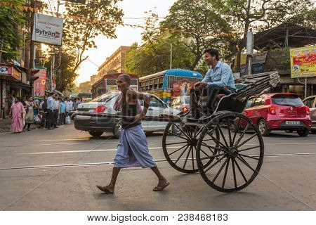 Kolkata, India - April 11, 2017: Traditional hand pulled indian rickshaw driver working on the street in Kolkata, West Bengal, India