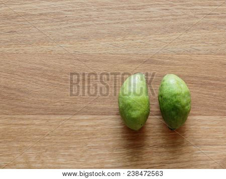 A Group Of Green Hog Plums Fruit, Which Look Like Small Mango, Over Bright Wooden Background With Co