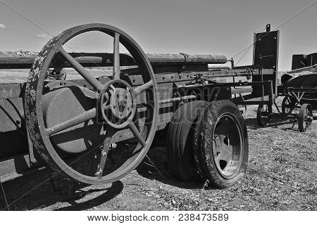 A Very Old Huge Fly Wheel Of A Baler Which Provides Power And Compression(black And White)