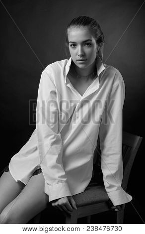 Young Pretty Woman In White Shirt . Beautiful Girl Onblack Background.
