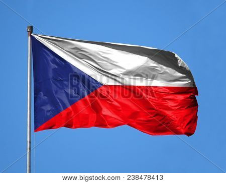 National Flag Of Czech Republic On A Flagpole In Front Of Blue Sky.