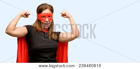Middle age super hero woman with red mask and cape happy and excited celebrating victory expressing big success, power, energy and positive emotions. Celebrates new job joyful isolated blue background