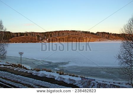View From The Window On Ice Covered Lake And Mountain Ahead