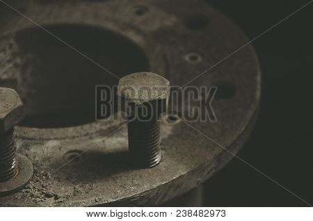 Old Rusty Bolts In The Dust On The Pipe Joint