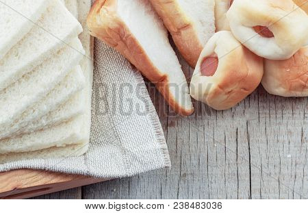 Many Breads On Tray And Wooden Floor.