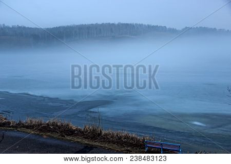 View From The Window On Ice Covered Lake And Mountain Ahead