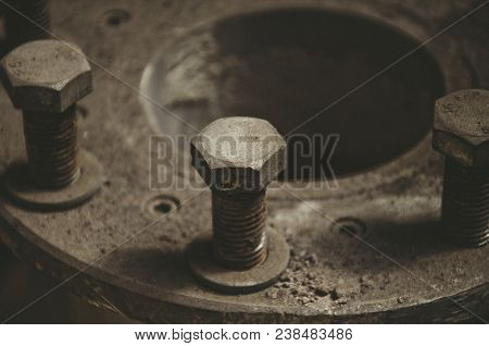 Old Rusty Bolts In The Dust On The Pipe Joint