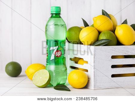 London, Uk - April 27, 2018: Plastic Bottle Of 7up Lemonade Soda Drink With Fresh Lemons And Limes.t