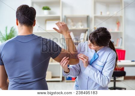 Doctor checking patients joint flexibility with gonimeter