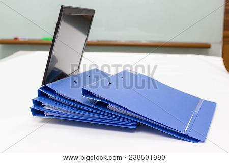 Blue File Folder With Documents And Notebook Background On The White Table Bisuness Concept.