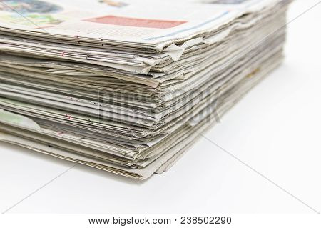 Closeup - Newspaper Stack On White Table In Office