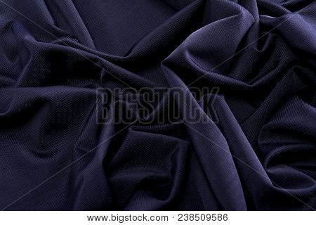 Smooth Dark Blue Satin Silk Fabric. Folds, Curl. Satin Background.