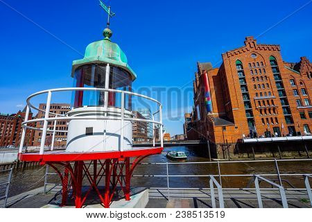 Old Beacon Or Small Lighthouse Near River Channel In Hamburg Hafencity.