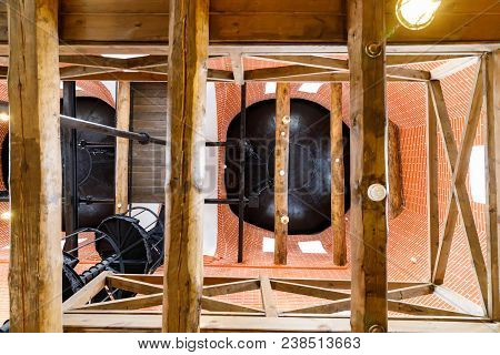 Old Spiral Staircase Made Of Cast Iron And Old Equipment And Wooden Floors In The Water Tower.