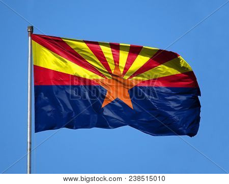National Flag State Of Arizona On A Flagpole In Front Of Blue Sky.
