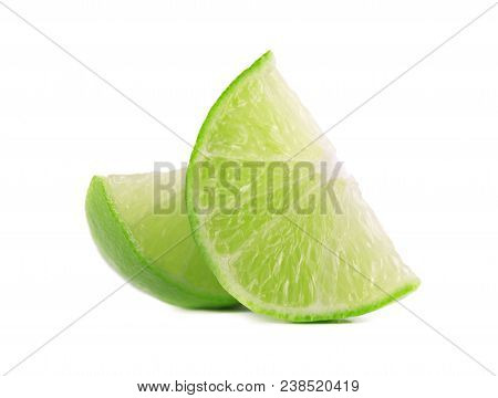 Ripe Slice Of Green Lime Citrus Fruit, Isolated On White Background. Lime Wedge With Clipping Path.