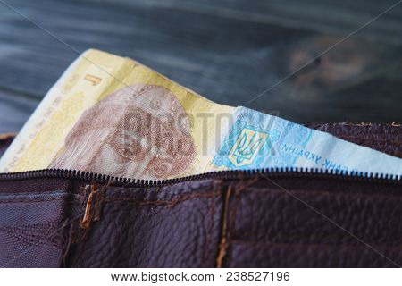 Ukrainian One Hrivna Bill In Old Shabby Leather Wallet On Wooden Table, Close Up