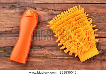 Yellow Mitt For Washing Car. Bottle Of Detergent And Microfiber Glove For Cleaning Automobile On Bro