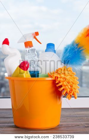Bucket With Cleaning Supplies. Cleaning Supplies Kit On Window Background. Cleaning Service Concept.